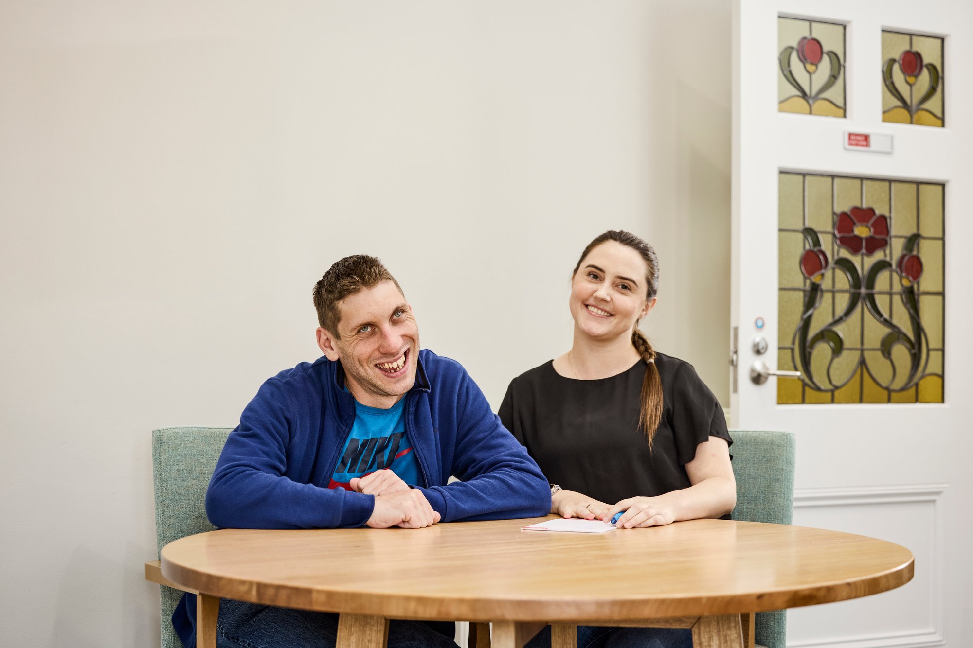 A man and woman sitting a round table.