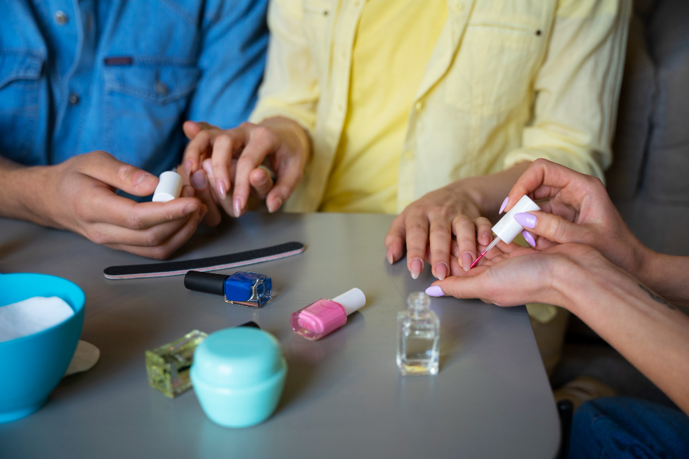 three people painting finger nails