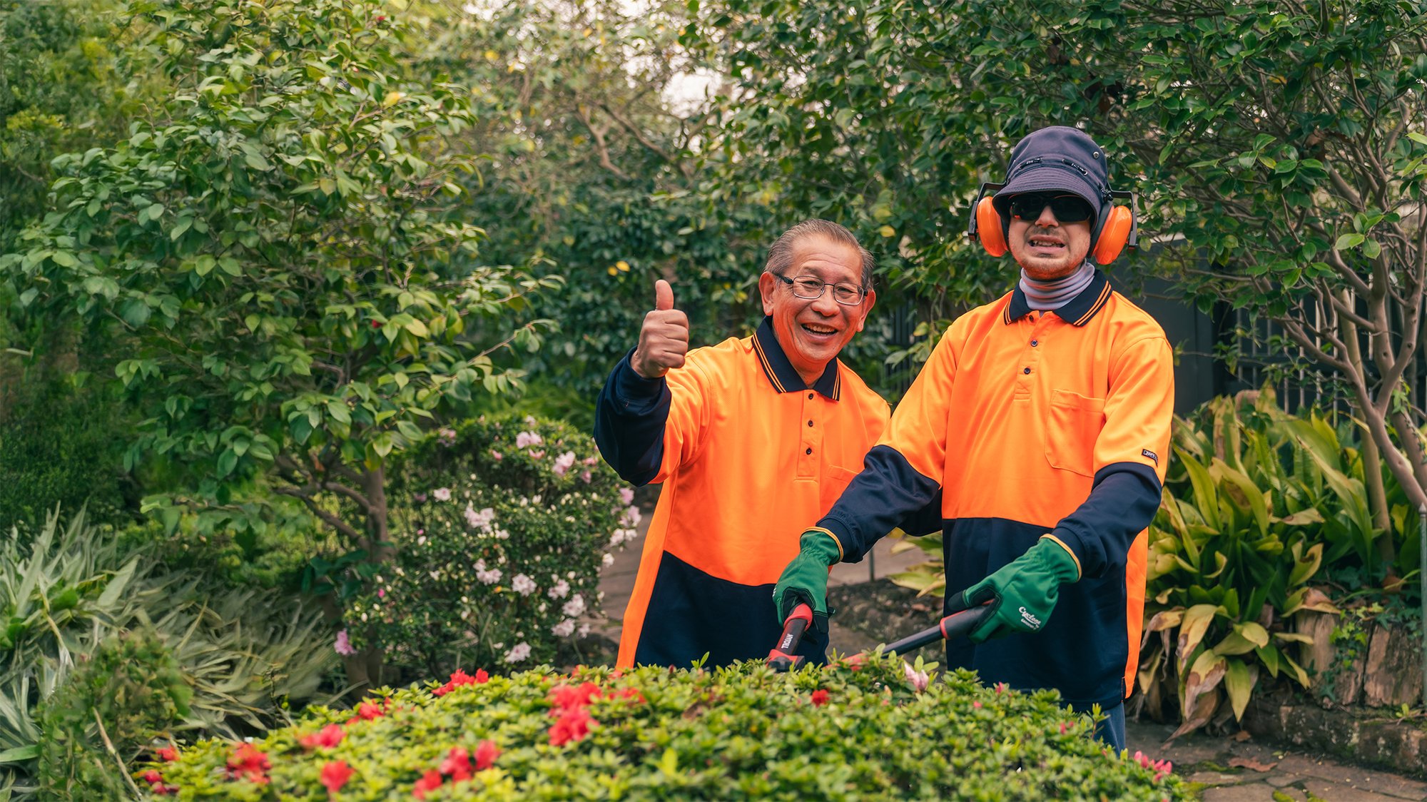 Two men standing in a garden