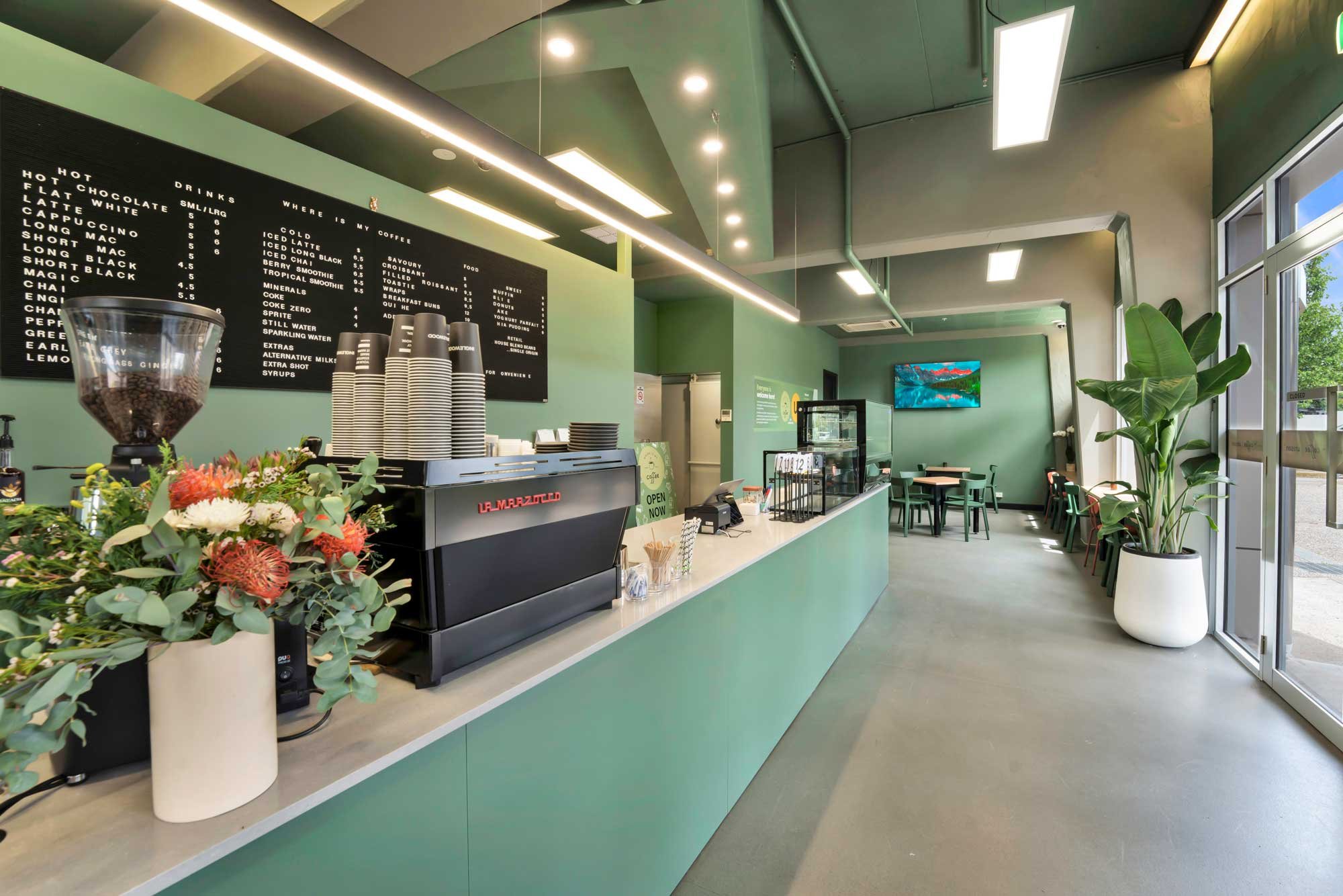 Inside a cafe with green counter and walls 