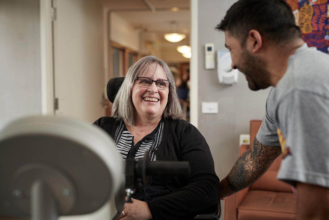 A support worker assisting a person with a disability as part of their daily routine at home.