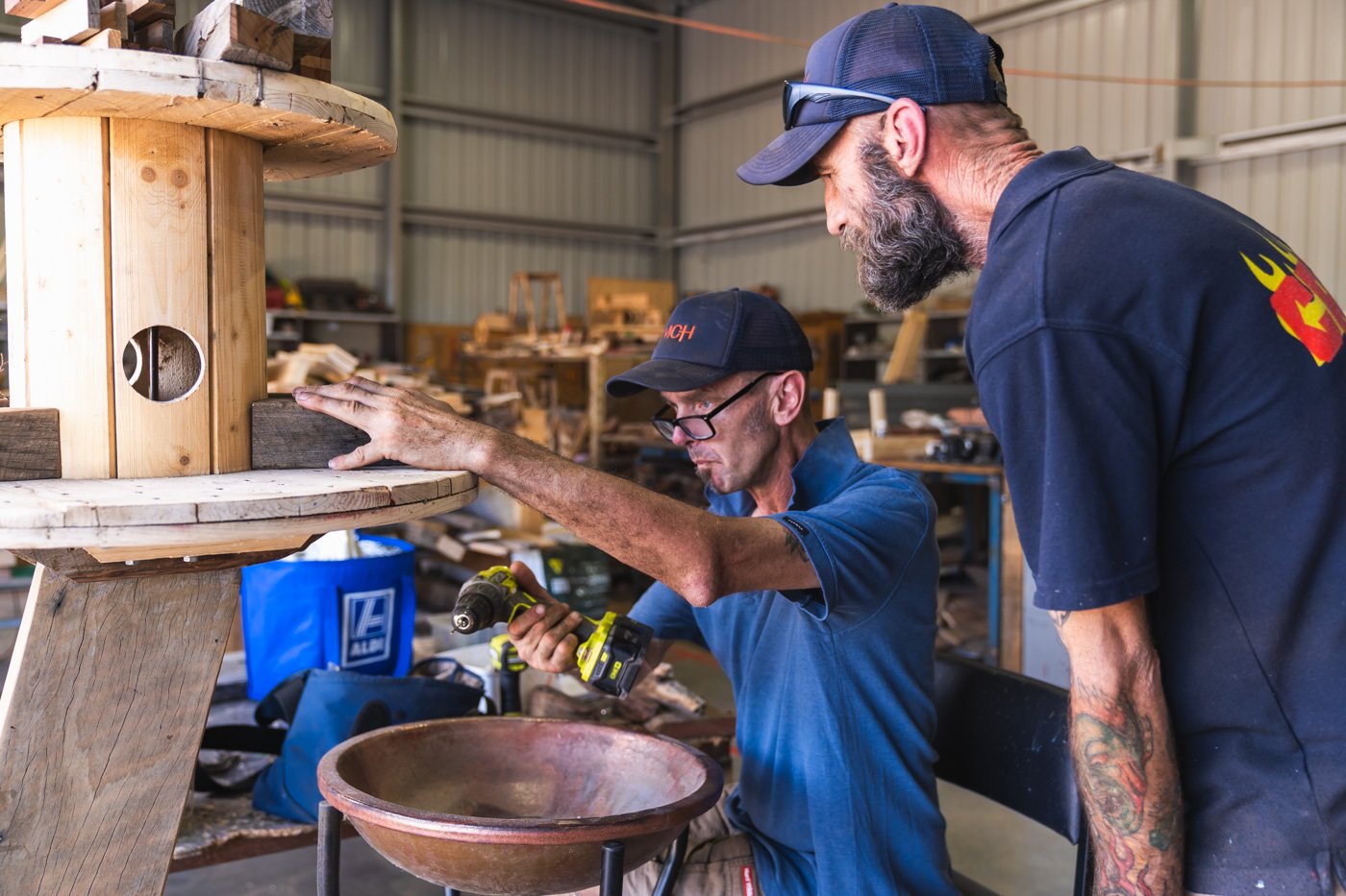 two men in a woodshed