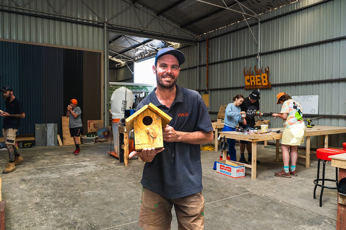 A man standing in a woodshed