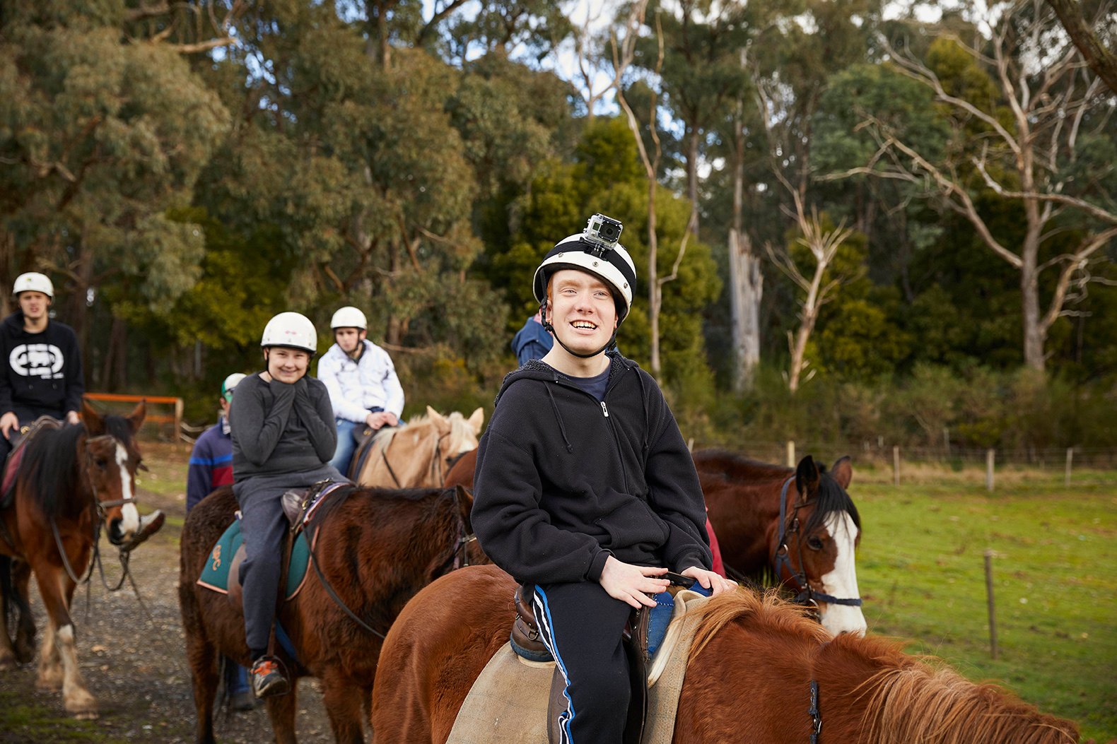 A group of people riding horses.